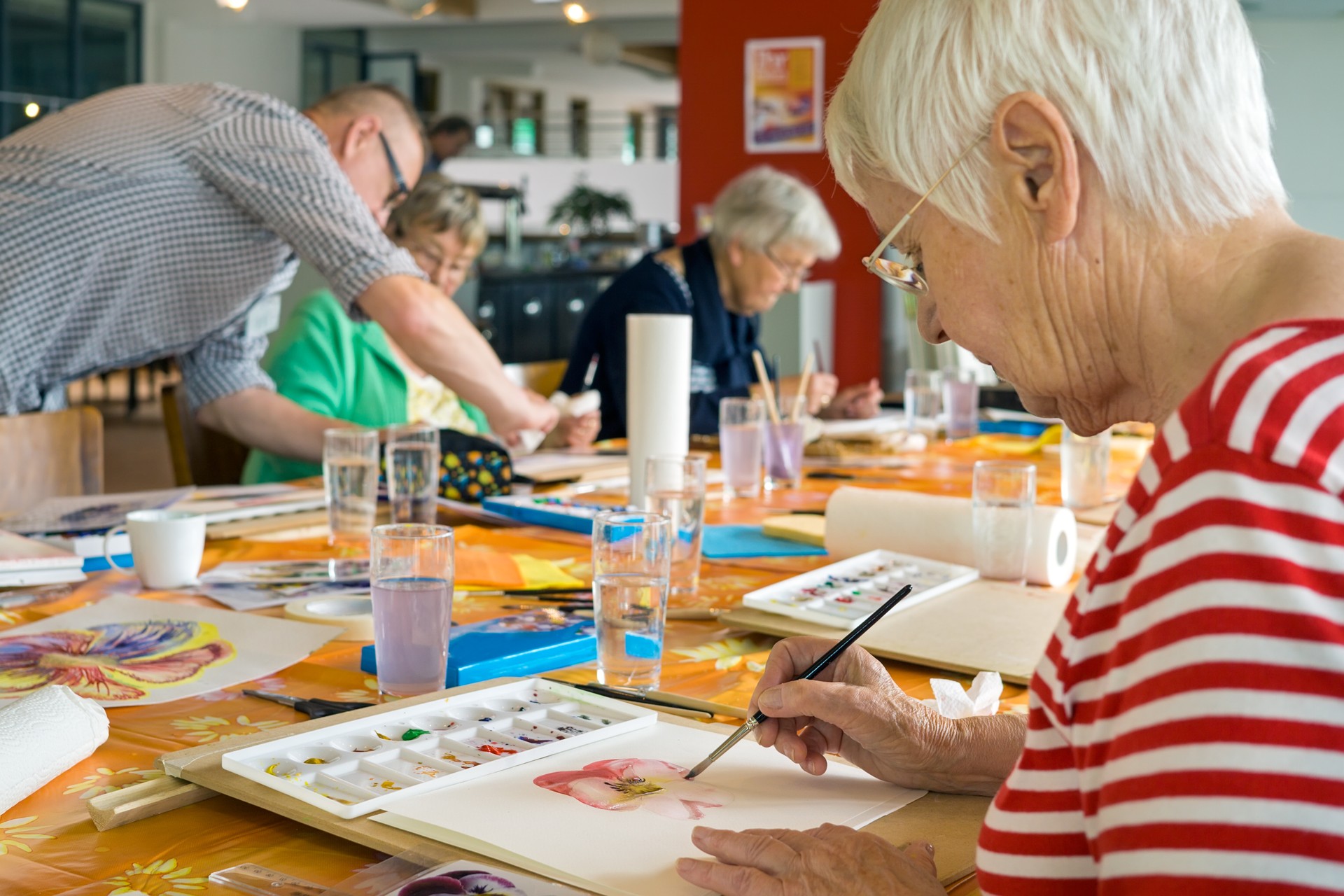 Woman working on watercolor painting.